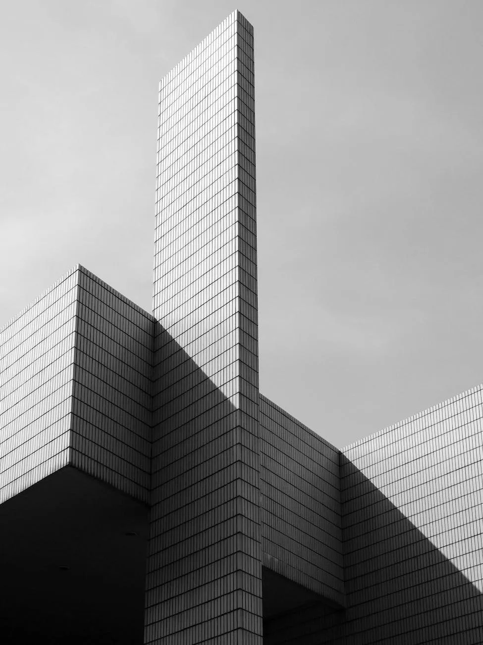 Black-and-white photo of a tiled building with stepped volumes against the sky