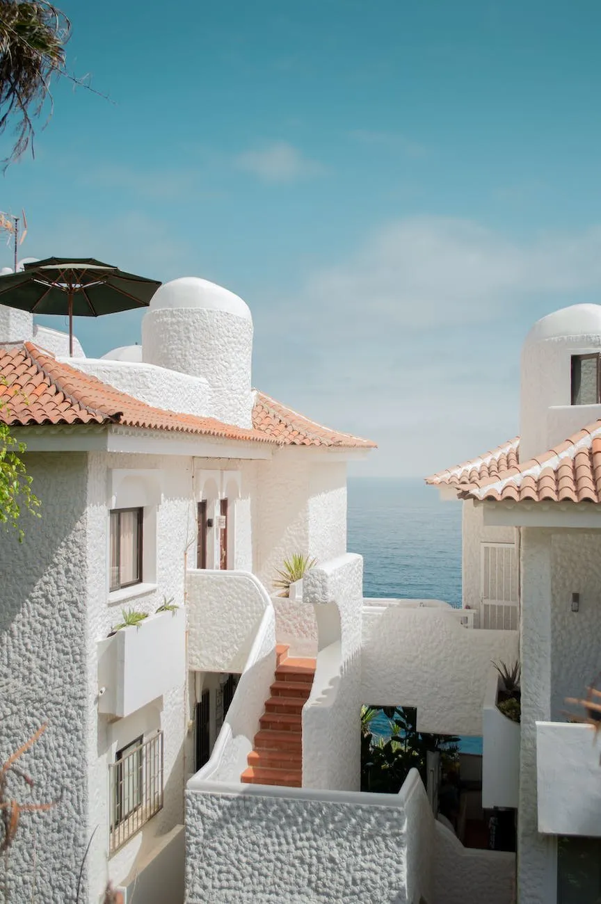 White Mediterranean houses with terracotta roofs and a parasol